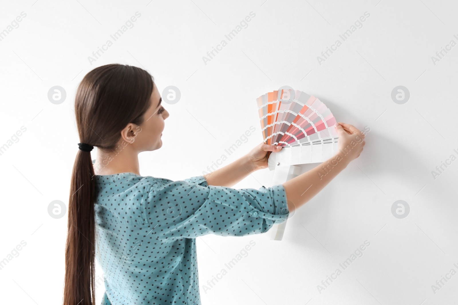 Photo of Young woman with color palette on white background