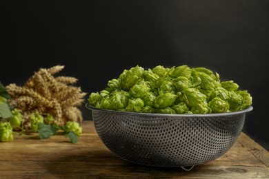 Fresh green hops and spikes on wooden table