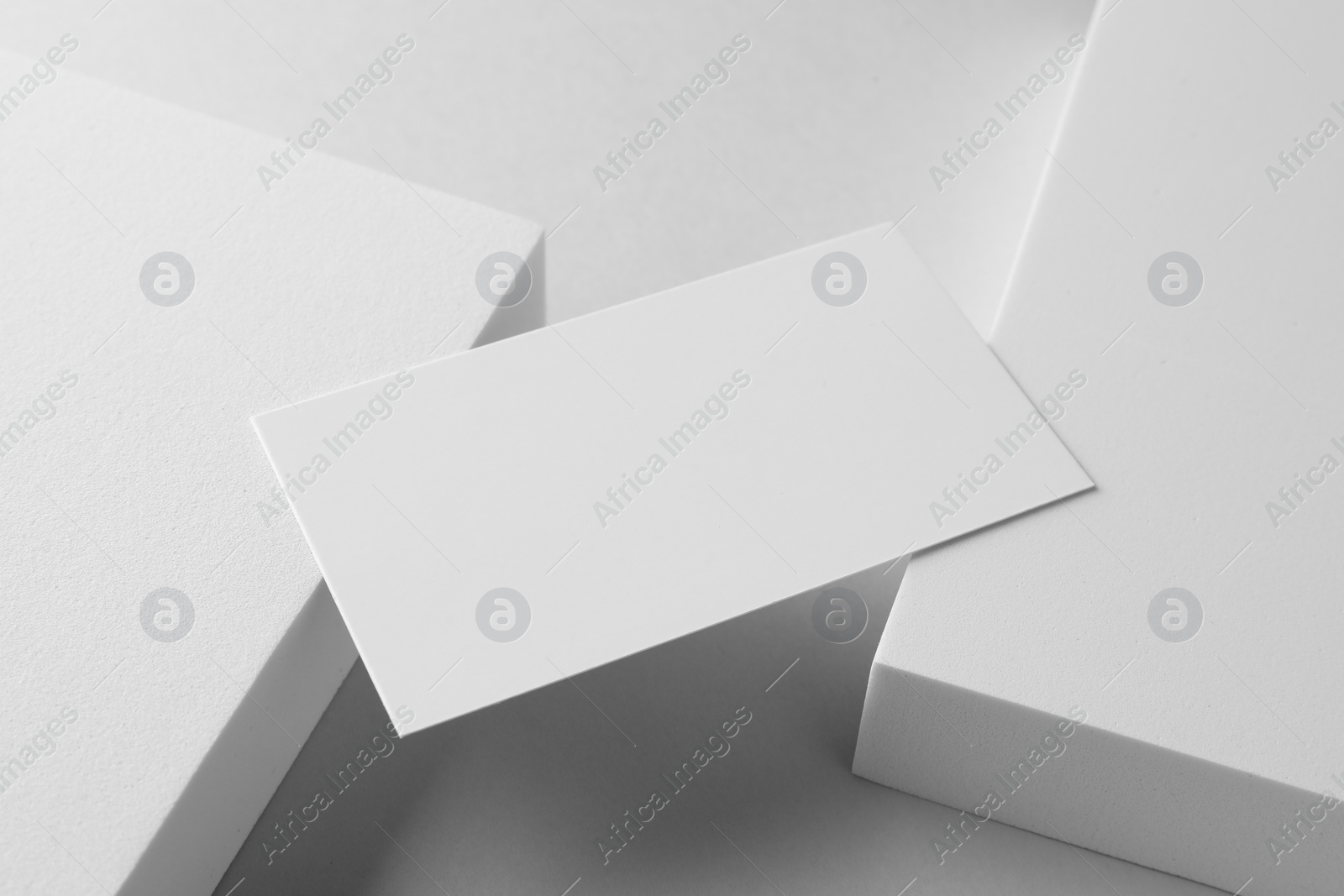 Photo of Empty business card and decorative elements on white background. Mockup for design