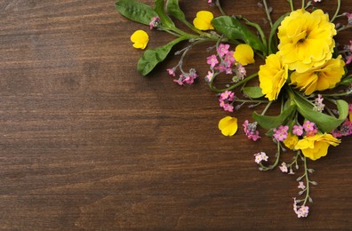 Beautiful composition with forget-me-not flowers on wooden table, flat lay. Space for text