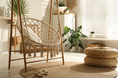 Comfortable hammock chair in stylish room. Interior design