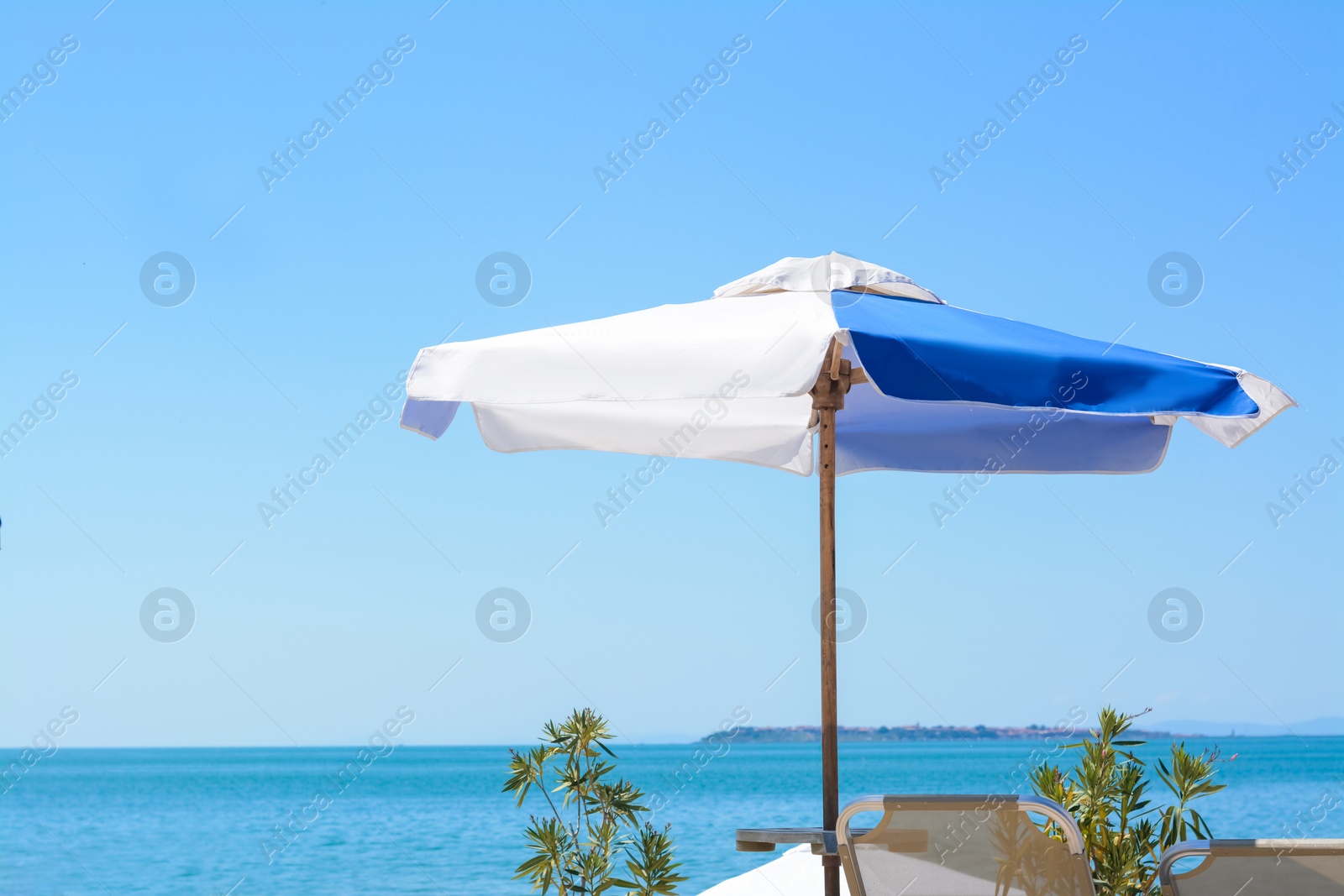 Photo of Blue and white beach umbrella at tropical resort