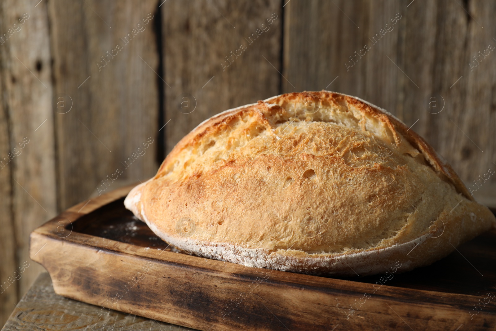 Photo of Freshly baked sourdough bread on wooden table