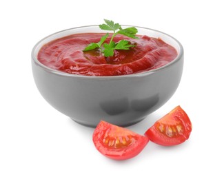 Photo of Organic ketchup with parsley in bowl and fresh tomato slices isolated on white. Tomato sauce