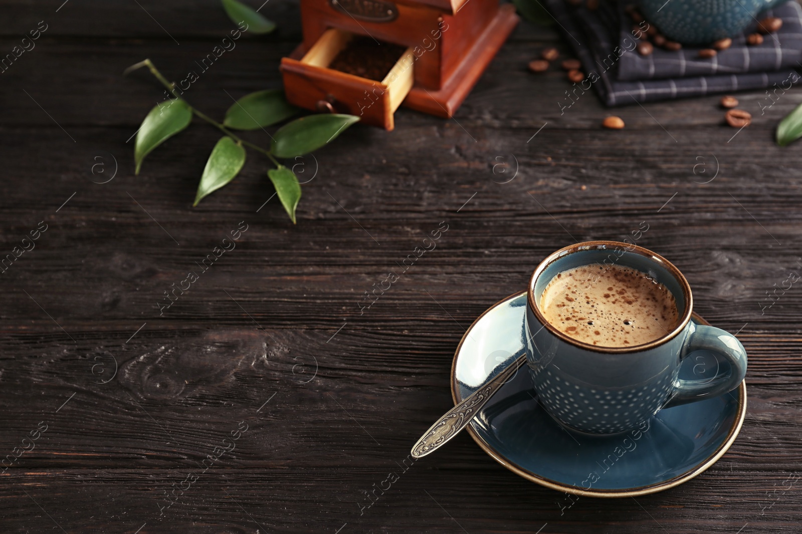 Photo of Cup of aromatic hot coffee on wooden table