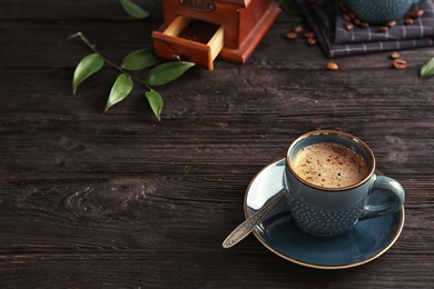 Cup of aromatic hot coffee on wooden table