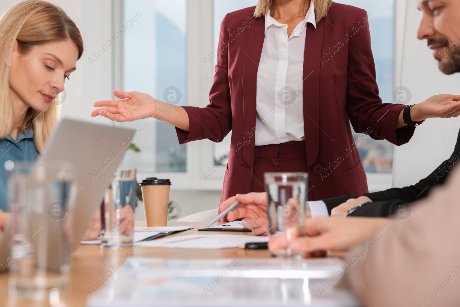 Photo of Businesswoman having meeting with her employees in office, closeup