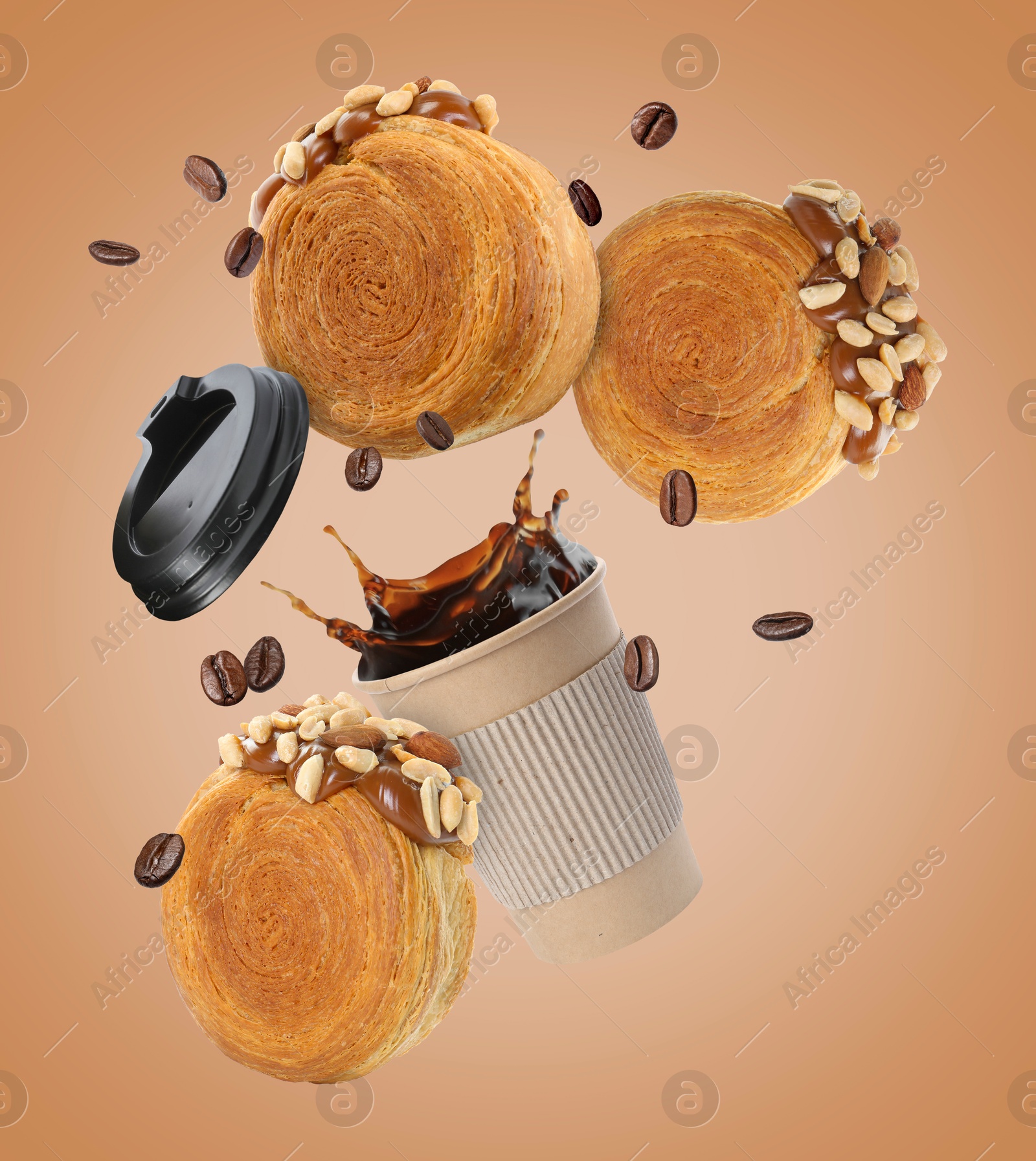 Image of Round croissants and coffee in air on dark beige background