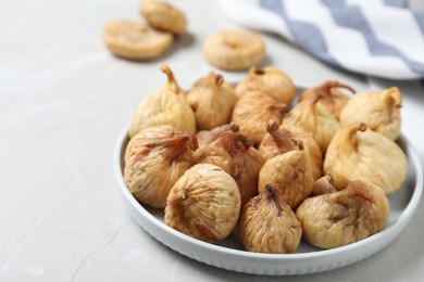 Tasty dried figs on light grey table, closeup