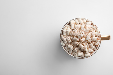 Delicious cocoa drink with marshmallows on white background, top view