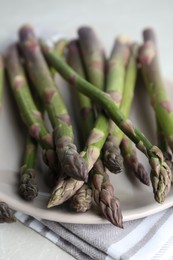 Fresh raw asparagus on table, closeup view