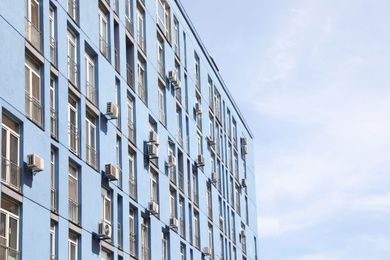 Colorful modern building with windows against sky. Urban architecture