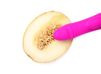 Half of melon and purple vibrator on white background, top view. Sex concept