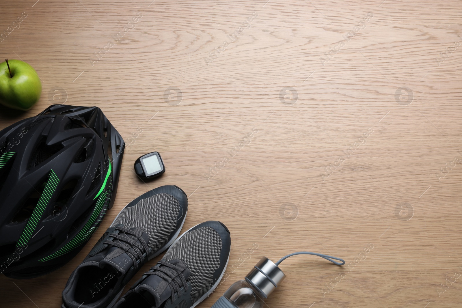 Photo of Flat lay composition with different cycling accessories on wooden background, space for text