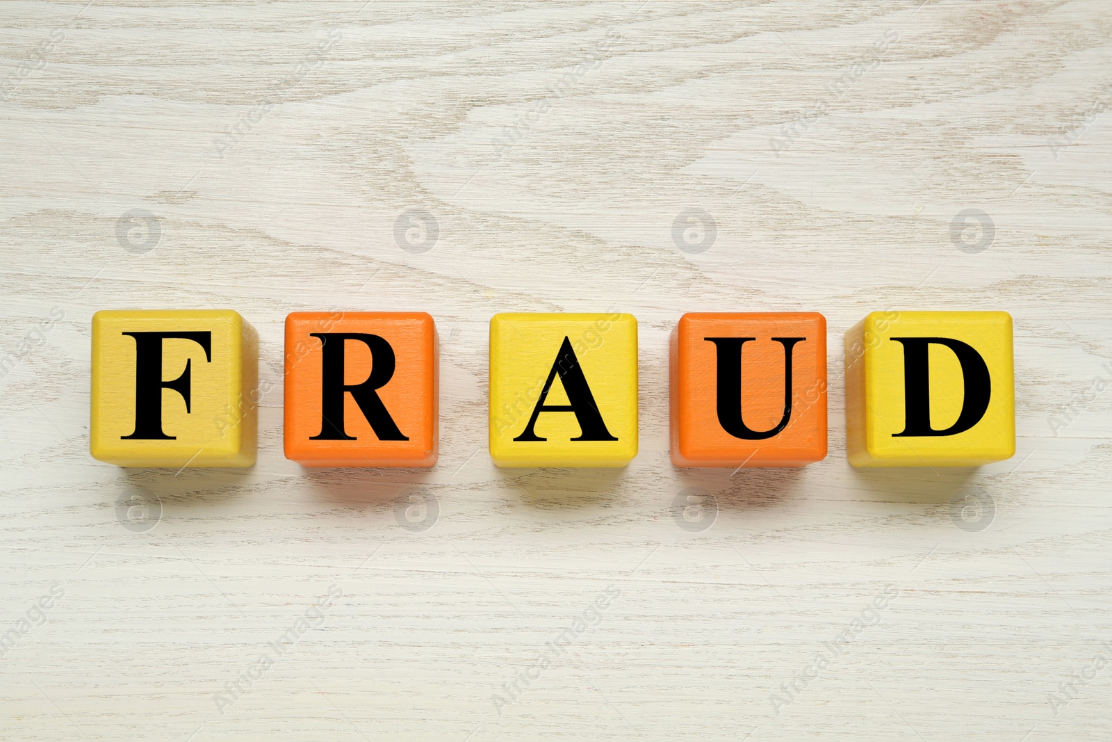 Photo of Word Fraud of cubes with letters on white wooden background, flat lay