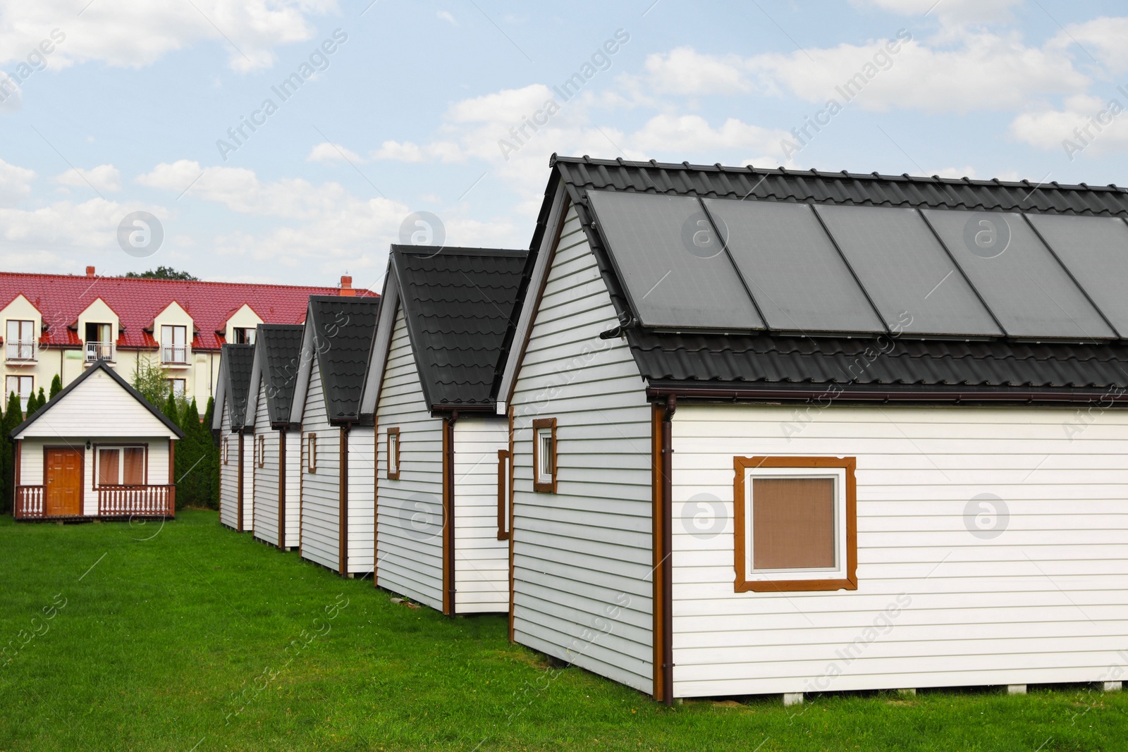 Photo of Beautiful wooden beach houses and green lawn outdoors