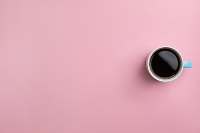 Photo of Ceramic cup with hot aromatic coffee on color background, top view