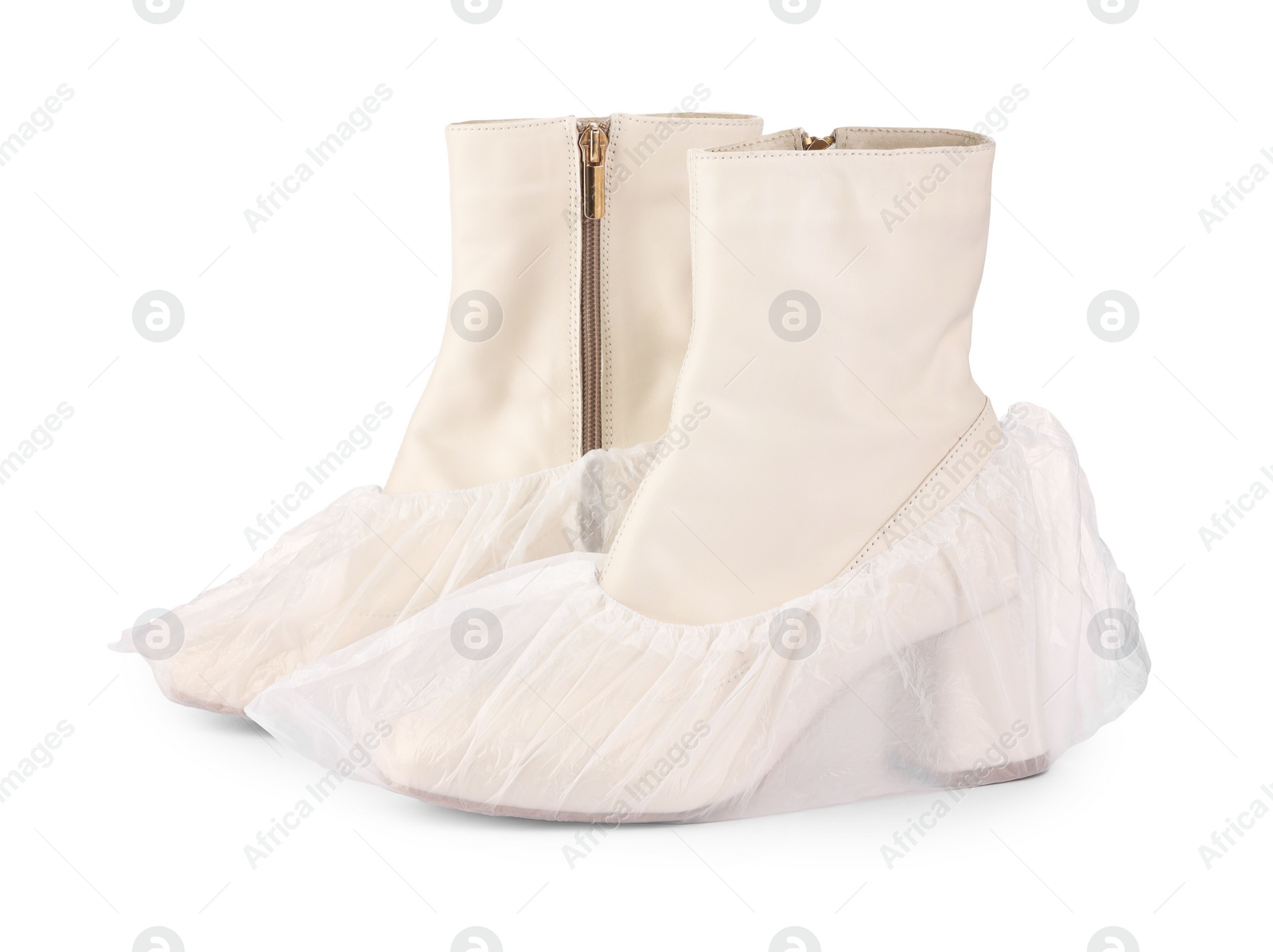 Photo of Women's boots in shoe covers isolated on white