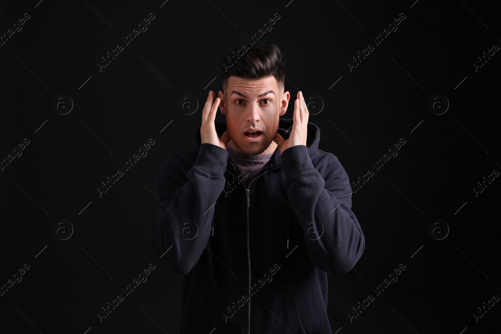Photo of Portrait of emotional man on black background. Personality concept