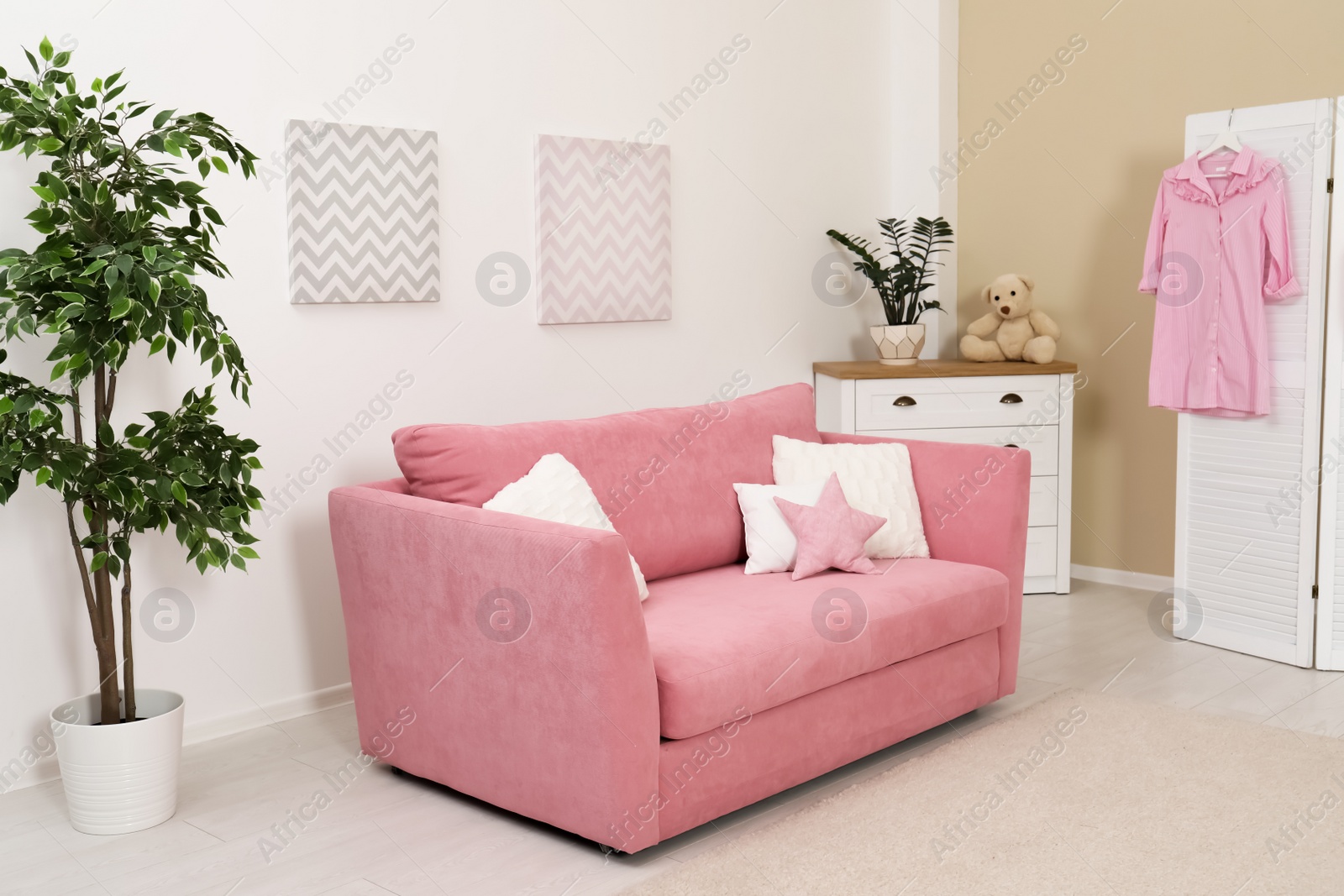 Photo of Cozy child room interior with sofa and modern decor elements