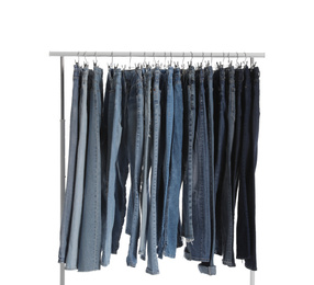 Rack with different jeans isolated on white