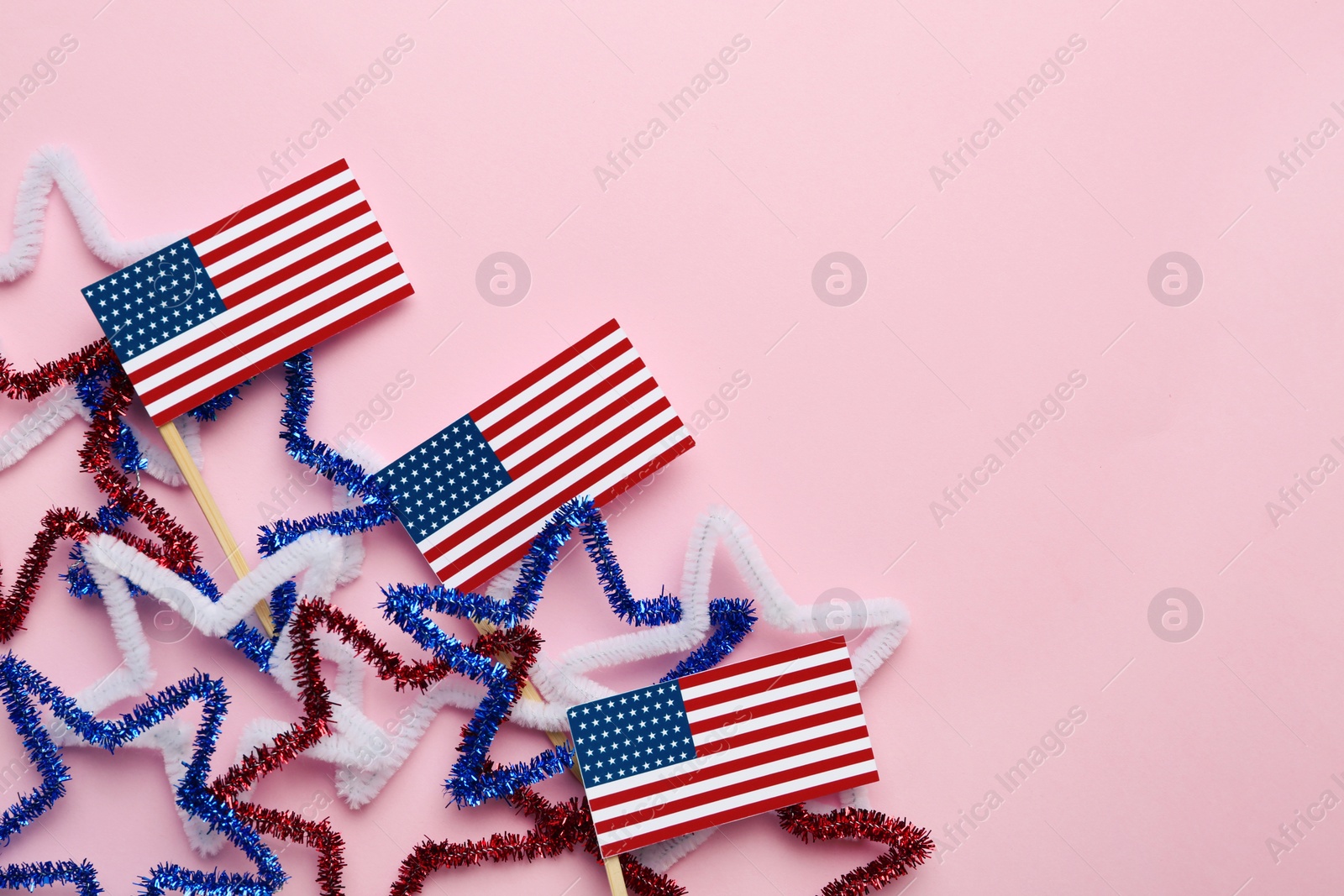 Photo of Flat lay composition with USA flags on color background, space for text. Happy Independence Day