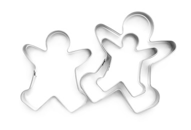 Gingerbread man cookie cutters on white background, top view