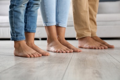 Photo of Family with little child together at home, closeup. Floor heating concept