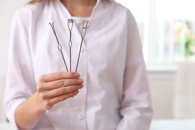 Speech therapist with logopedic probes in clinic, closeup. Space for text