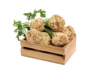 Photo of Wooden crate with fresh raw celery roots isolated on white