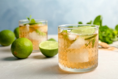 Photo of Composition with delicious mint julep cocktail on table