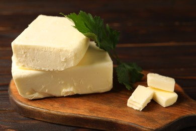 Tasty butter and parsley on wooden table, closeup