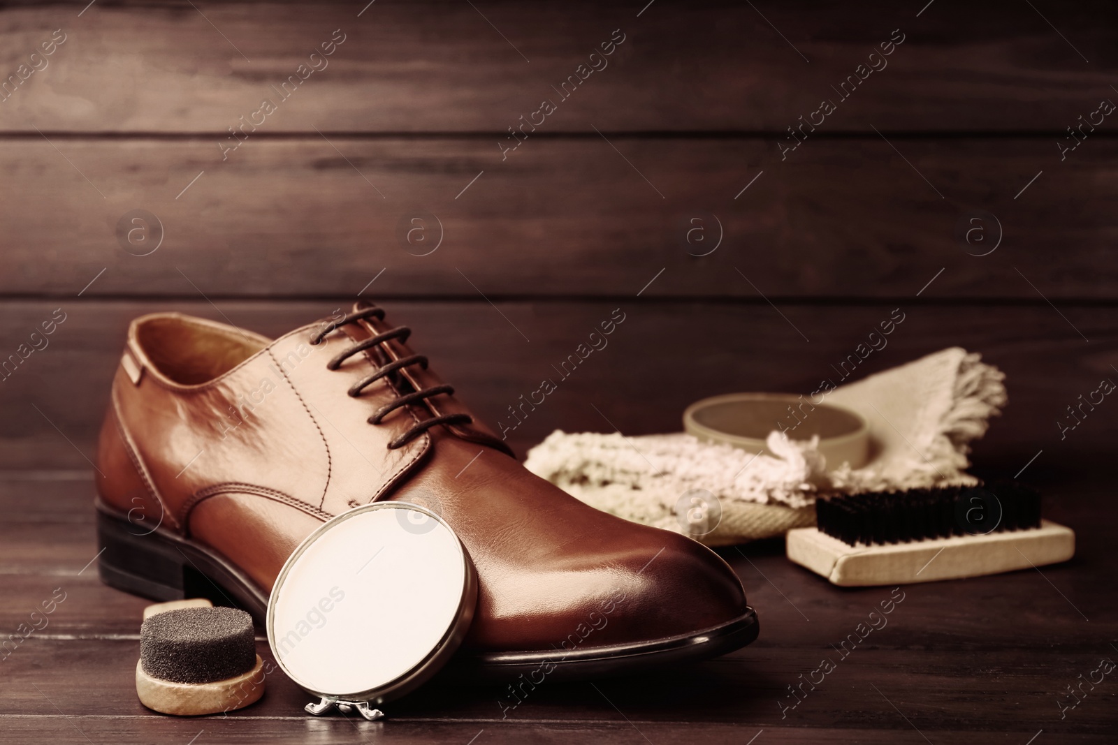 Image of Footwear care accessories and shoe on wooden background