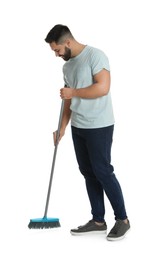 Young man with broom on white background
