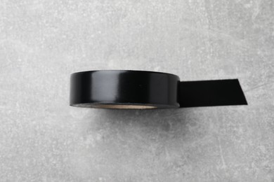 Black insulating tape on light grey table, top view