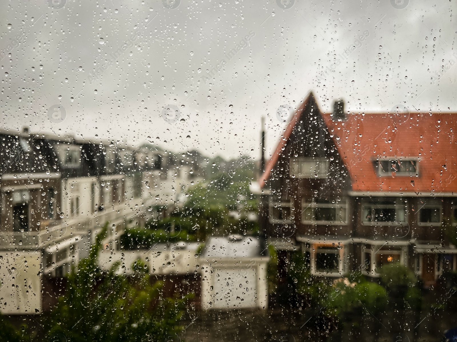 Photo of Window glass with water drops, view from inside. Rainy weather