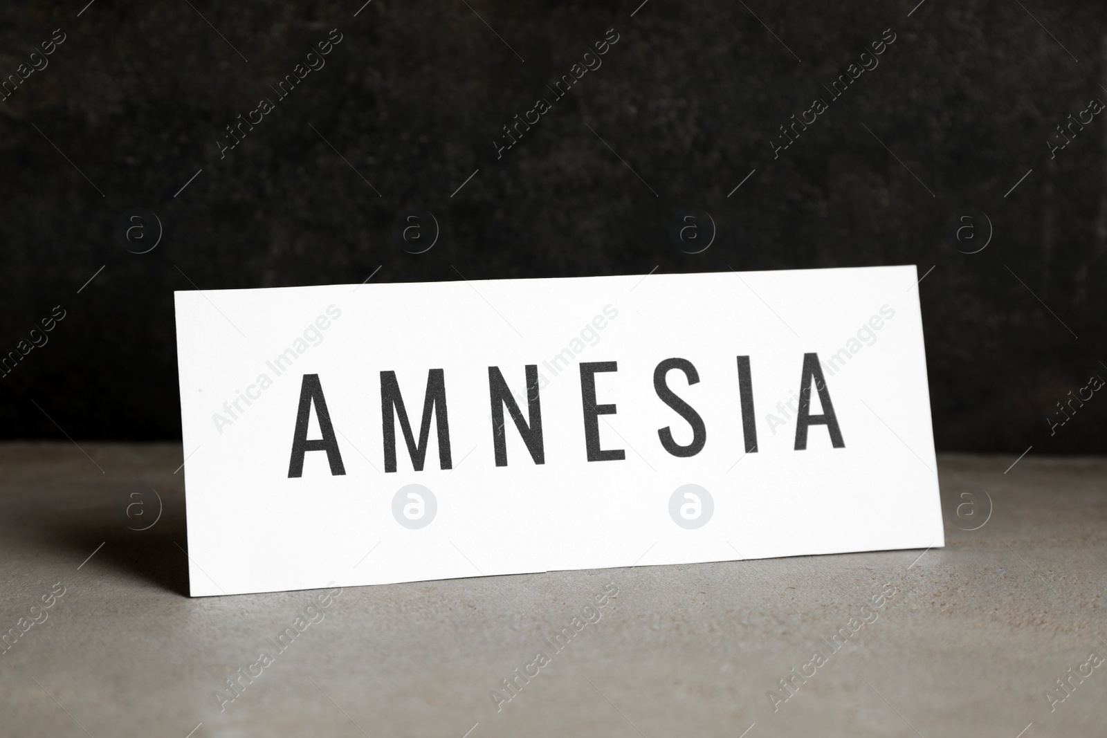 Photo of Card with word Amnesia on light grey table