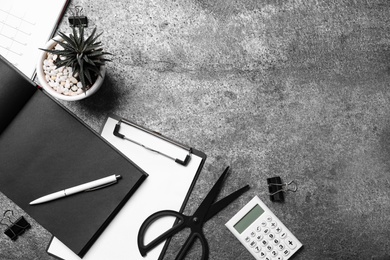 Photo of Flat lay composition with succulent and office items on grey stone table. Space for text