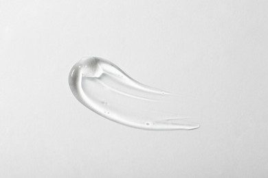 Photo of Sample of cosmetic gel on white background, top view