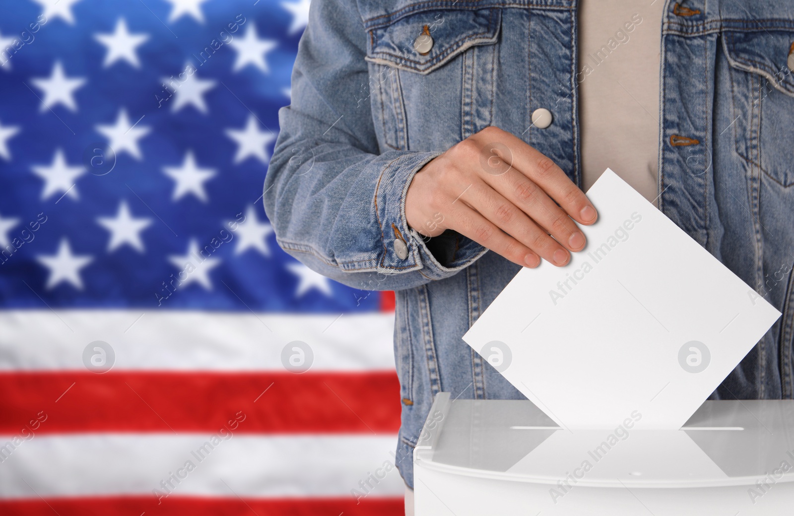 Image of Election in USA. Man putting his vote into ballot box against national flag of United States, closeup. Space for text