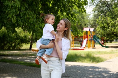 Happy mother with her daughter spending time together in park