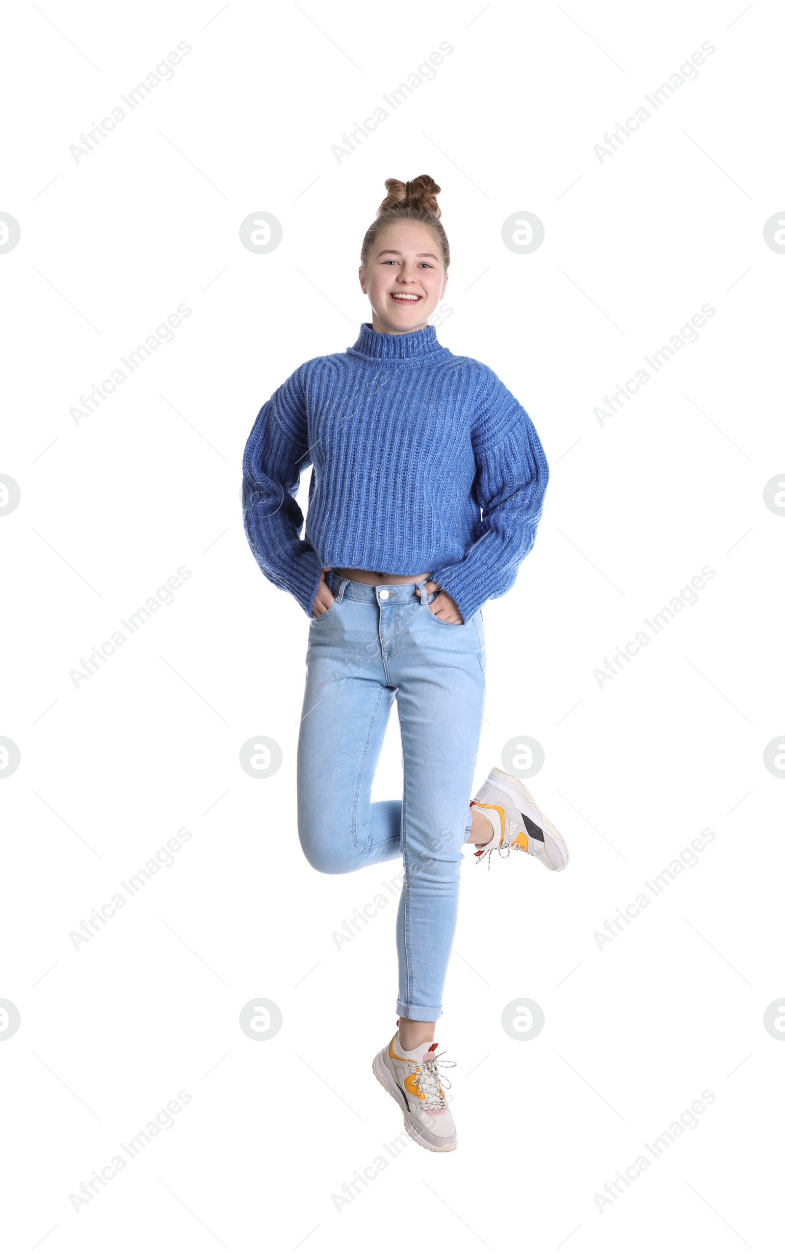 Photo of Pretty teenage girl jumping on white background