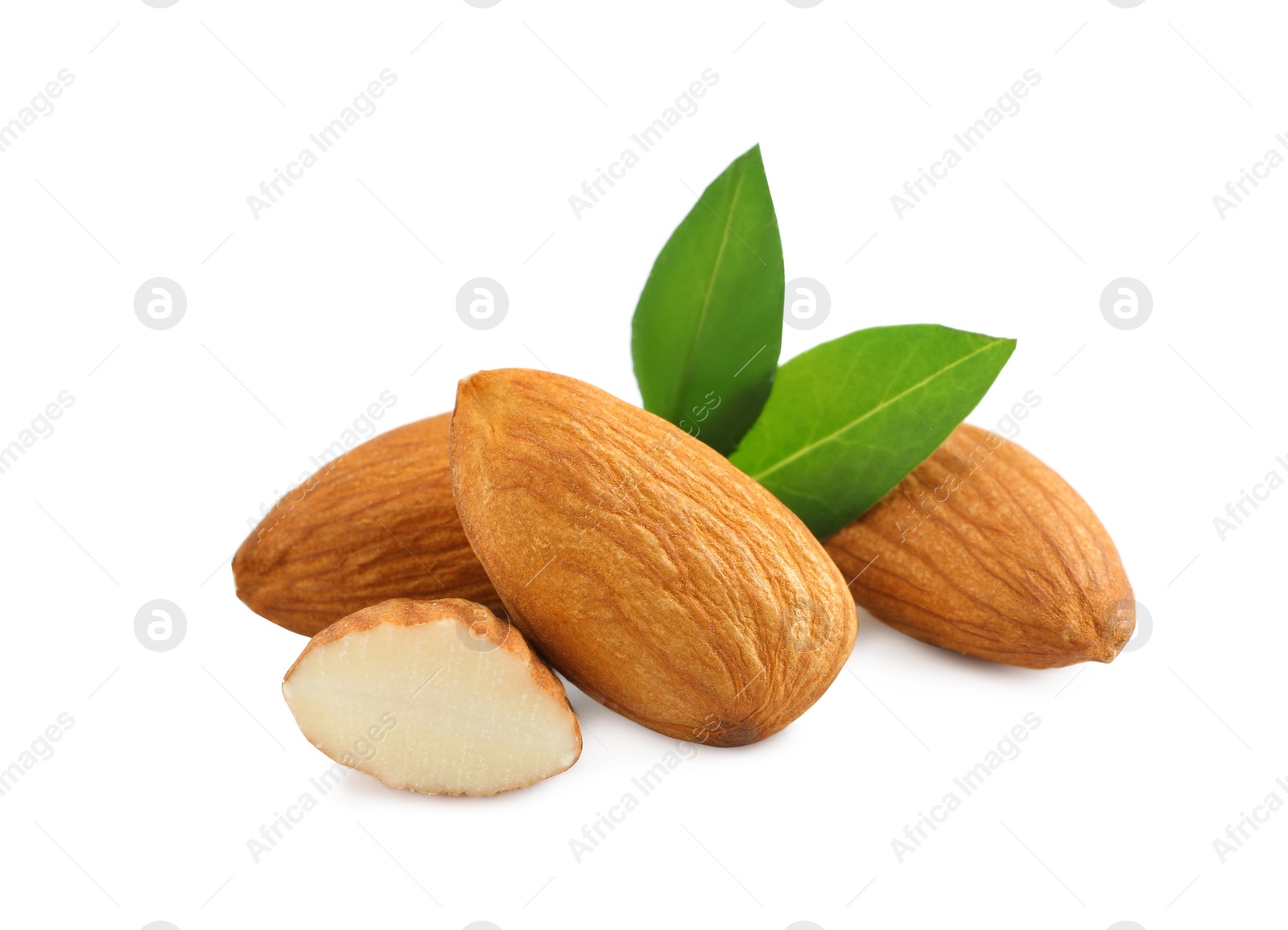 Photo of Organic almond nuts and green leaves on white background. Healthy snack