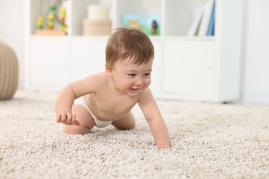 Photo of Cute baby boy crawling on carpet at home