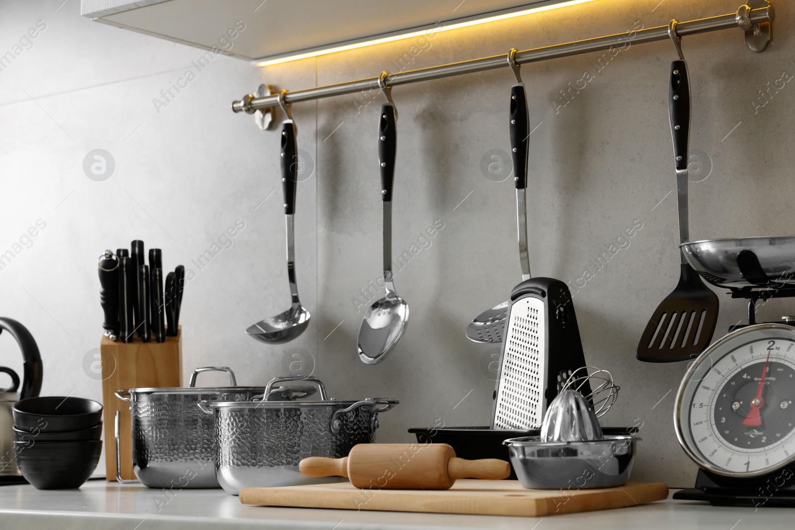 Photo of Set of different utensils on countertop in kitchen