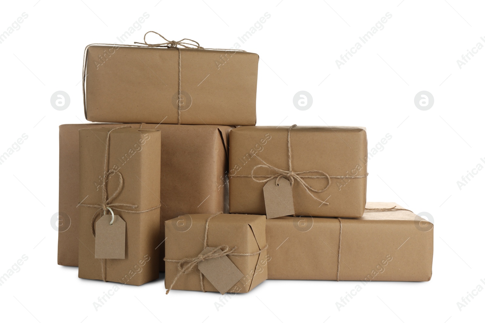 Photo of Parcels wrapped in kraft paper with tags on white background