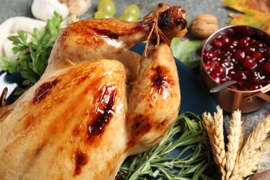 Photo of Composition with delicious turkey and autumn vegetables on grey background, closeup. Happy Thanksgiving day