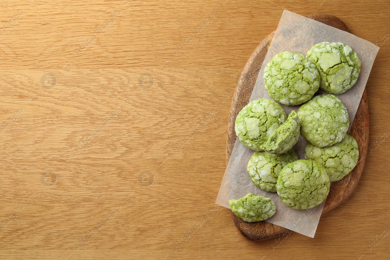 Photo of Tasty matcha cookies on wooden table, top view. Space for text