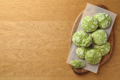 Tasty matcha cookies on wooden table, top view. Space for text