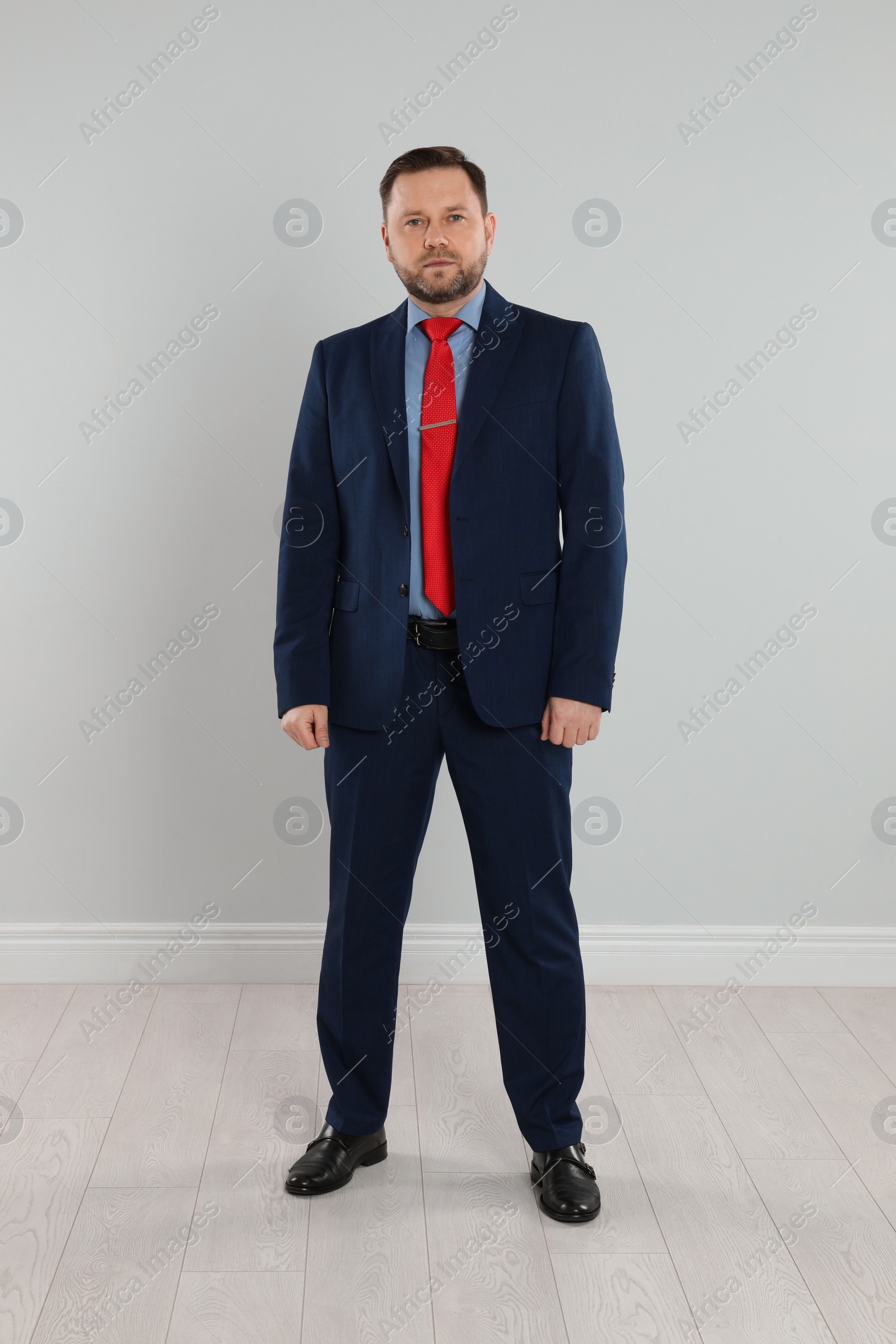 Photo of Full length portrait of mature man near light grey wall